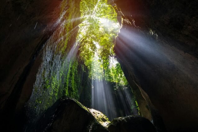 Rays of light at Tukad Cepung Waterfall in Bali, Indonesia